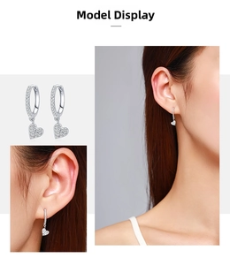 Detail of s925 silver heart earrings featuring micro-pave cubic zirconia on Asian model