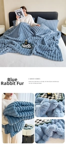 Close-up of thick rabbit-hair flannel blanket with blue carved stripes and soft texture