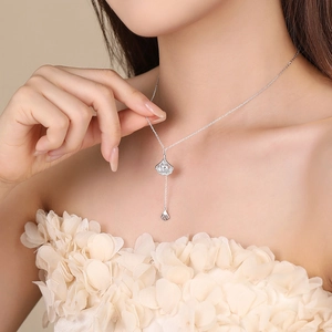 Elegant S925 sterling silver ginkgo leaf necklace with tassel and cubic zirconia on model