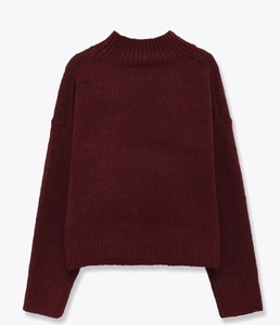 Detail of burgundy knit sweater showing mock neck ribbing and thick wool texture
