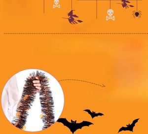 Detail of Halloween tinsel garland with orange pumpkin cutouts for festive party decor