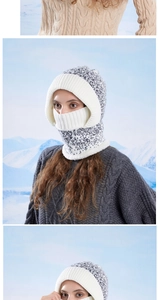 Close-up of winter knit hooded scarf set with integrated face mask in grey mixed yarn