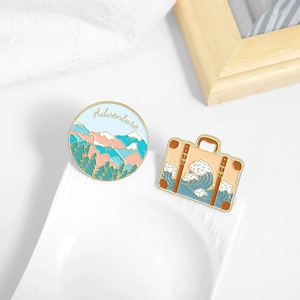 Adventure enamel pin set with mountain forest and ocean wave luggage bag designs
