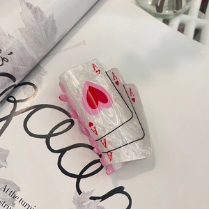 Close-up of Ace of Hearts acrylic hair claw with pearlescent finish and pink teeth