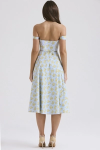 Detail view of the back of a light blue floral dress with elegant yellow flower patterns