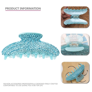 Detail view of blue acrylic shark clip with sparkling rhinestones and spring mechanism