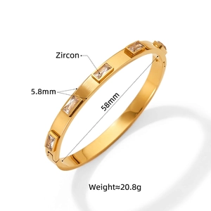 Polished gold stainless steel bangle with rectangular zircons and mechanical clasp