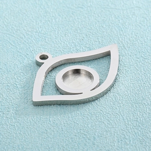 Detailed view of silver stainless steel Eye of Horus pendant with round bezel base for DIY