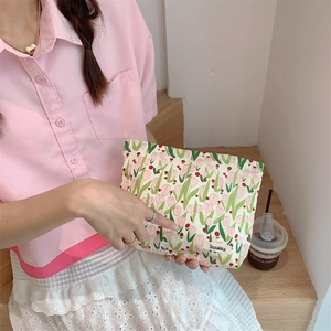 Floral tulip canvas cosmetic bag detail with woven Sozakka brand label on natural fabric