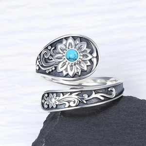 Macro detail of S925 sterling silver sunflower ring with turquoise stone and vintage texture