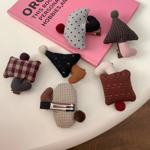 Detail showing colorful fabric mushroom hair clips with polka dots and plaid patterns