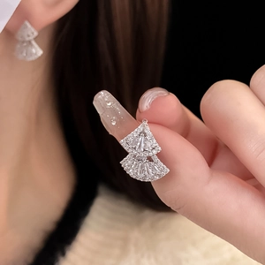 Macro detail of silver layered fan earrings featuring brilliant pavé-set zircons