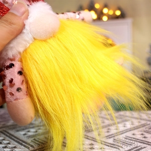 Detail of Christmas Rudolf gnome with yellow long beard and pink sequined limbs and body