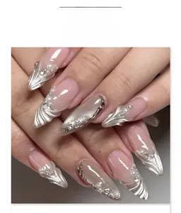Detail of French cat eye press-on nails with 3D water ripples and pearl accents