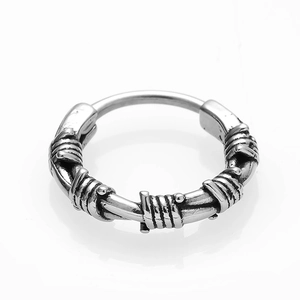 Macro shot of punk style barbed wire hoop earrings in antique silver stainless steel