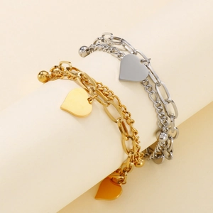 Dual-layer heart pendant chain bracelets in gold and silver finish on display