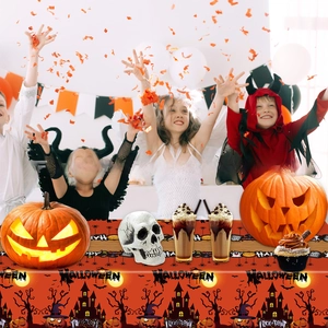Halloween party tablecloth with orange silhouette designs featuring pumpkins and bats
