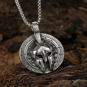 Silver Viking warrior helmet pendant necklace with Greek key pattern on wooden background
