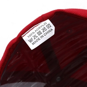 Detailed macro view of internal care label and red acrylic fabric on a baseball cap
