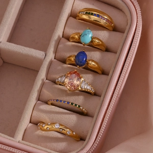 Detail of 18K gold plated ring set with turquoise and colorful stones in a velvet box