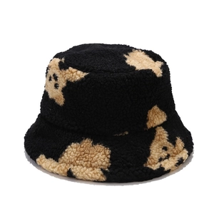 Women's black faux shearling bucket hat with cute beige bear pattern for winter warmth