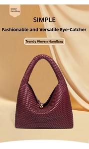 Close-up of woven deep red leather handbag with elegant gold metal sphere clasp detail