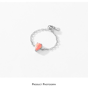 Detailed shot of S925 sterling silver drop ring with pink opal and soft chain design