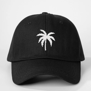 Detailed view of white palm tree embroidery on a vintage black cotton baseball cap