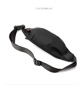 Close-up of black nylon mini waist bag with red tag and refined zipper details