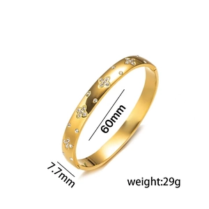Golden stainless steel bangle with sparkling four-leaf flower rhinestones 60mm diameter