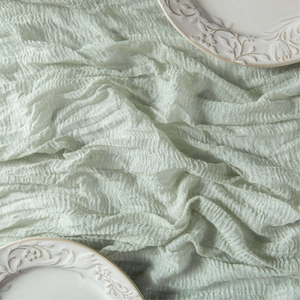 Sage green cheesecloth table runner with rustic boho pleated texture for weddings