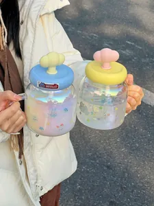 Detailed view of an iridescent cloud glass cup with a cute bear pattern and a straw