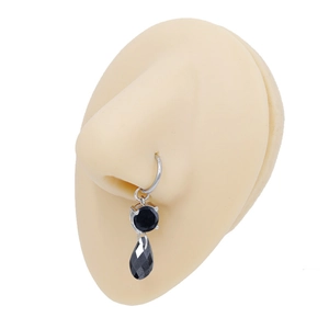 Détail d'un anneau de nez argenté avec pierre noire et pendentif en forme de larme