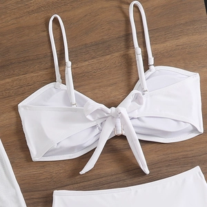 Detailed back view of white strapless bikini with a large decorative bow and adjustable straps