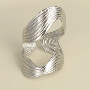 Detailed view of silver stainless steel wide band ring with unique ripple texture finish