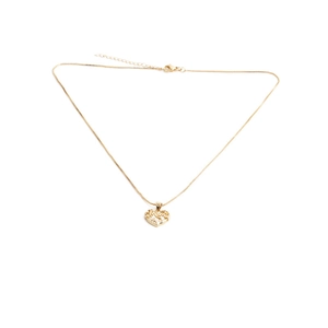 Macro detail of gold heart pendant with hollow MUM lettering and shiny cubic zirconia
