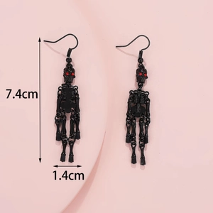 Detailed view of Gothic black skeleton earrings with red rhinestones and 7.4cm measurement