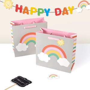 Grey rainbow gift bag with pink ribbon handle and cartoon cloud print for bakery