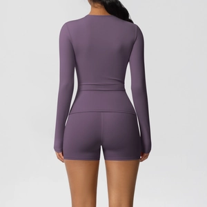 Detail of deep purple long-sleeve yoga top and high-waist shorts set from back view