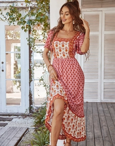 Detail of bohemian pink floral dress featuring square neck and tiered ruffle hemline