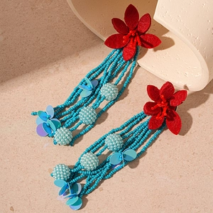 Exaggerated contrast floral beaded tassel earrings in red and turquoise finish