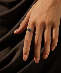 Close-up of S925 silver evil eye ring with blue crystal and dark vintage metal finish