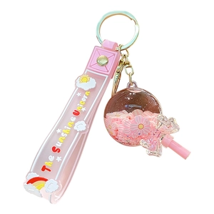 Pink quicksand unicorn keychain with flower petal sequin ball and lollipop pendant charm