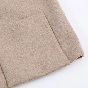 Detail of khaki wool blend coat showing refined stitching and functional side pocket