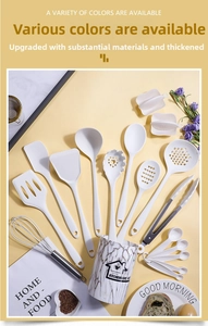 White silicone kitchen utensil set with stainless steel handles in a marble storage holder