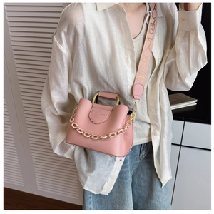 Detail of pink vintage handbag with gold chain, metal handle and Molly embroidered strap