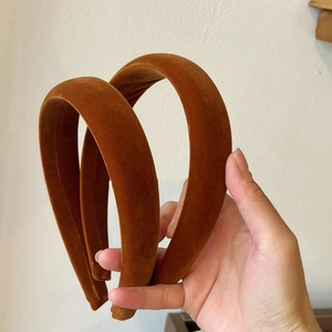Close-up of caramel brown velvet padded headband featuring a thick high-top design