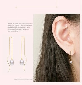 Close-up of elegant S925 silver gold chain drop earrings with natural white pearls