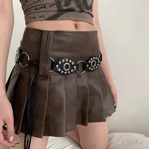 Close-up of brown pleated mini skirt with Y2K vintage rivet belt and metal rings