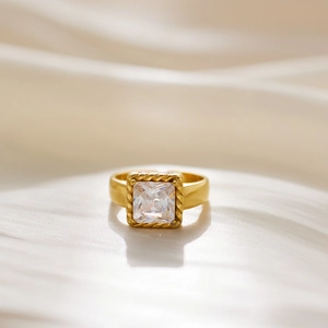 Close-up of vintage gold ring with square cubic zirconia and twisted rope frame detailing